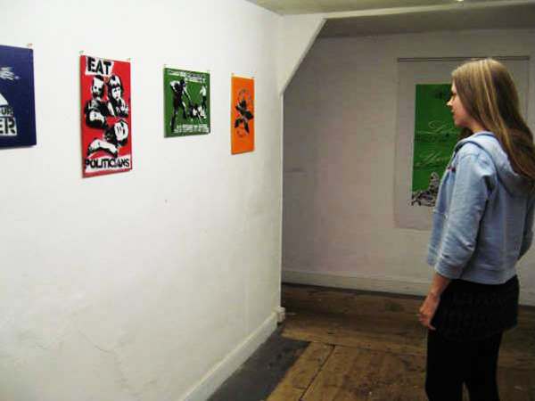 Smaller political stencils from another angle at the Stolen Wall Exhibition /  Revolting Mass street art show
