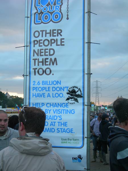 Love you Loo fundraising banner plus Revolting Mass stencil at Glastonbury Festival Sommerset
