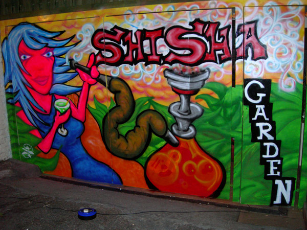 Graffiti of Woman Smoking Shisha Pipe on Pub Gates