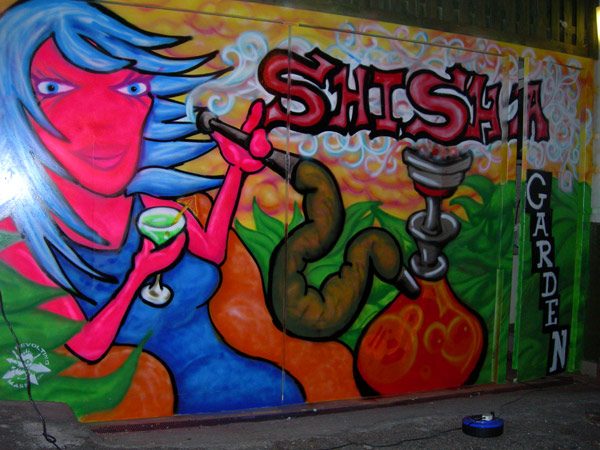 Graffiti of Woman Smoking Shisha Pipe on Pub Gates