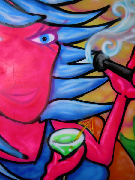 Graffiti of Woman Smoking Shisha Pipe on Pub Gates