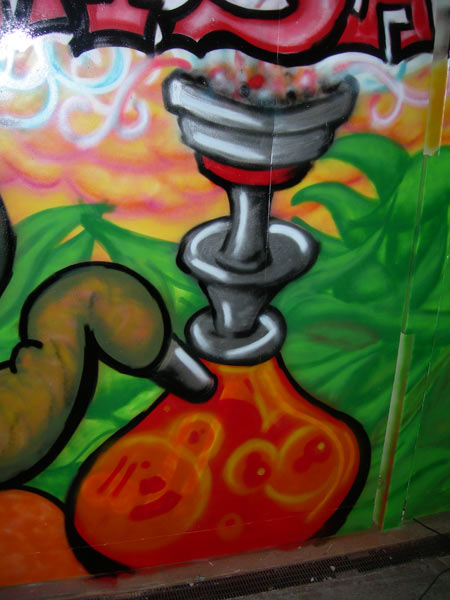 Graffiti of Woman Smoking Shisha Pipe on Pub Gates